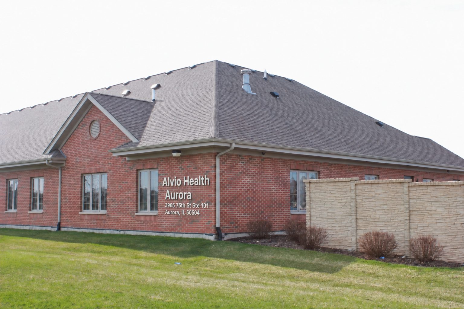 The building from the corner, showing the Alvio Health Aurora signage